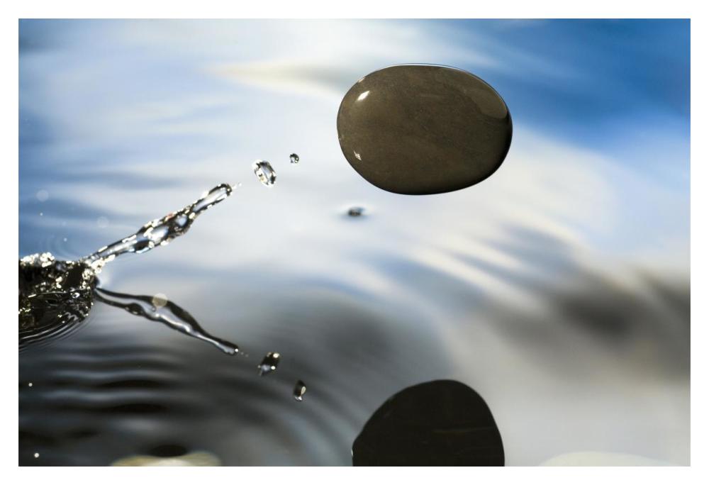 A rock skipping across the water's surface-Paper Art-20"x14"