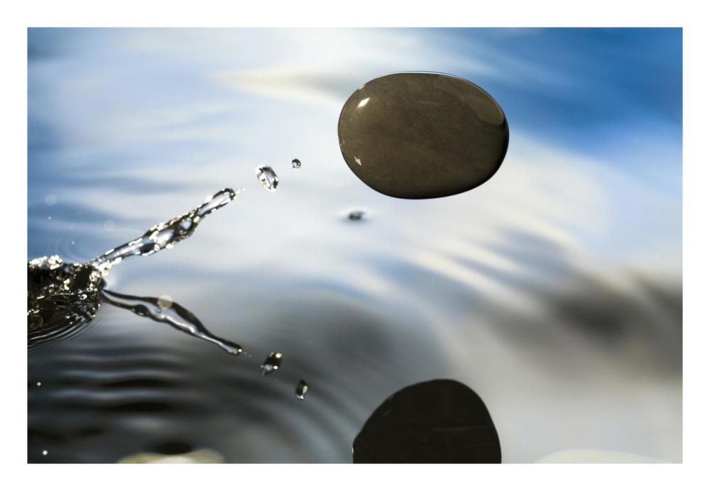 A rock skipping across the water's surface-Paper Art-26"x18"