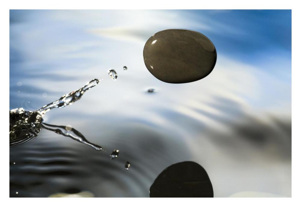 A rock skipping across the water's surface-Paper Art-32"x22"