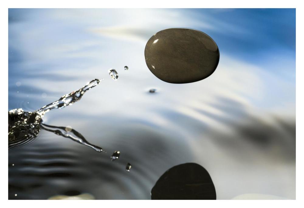A rock skipping across the water's surface-Paper Art-38"x26"
