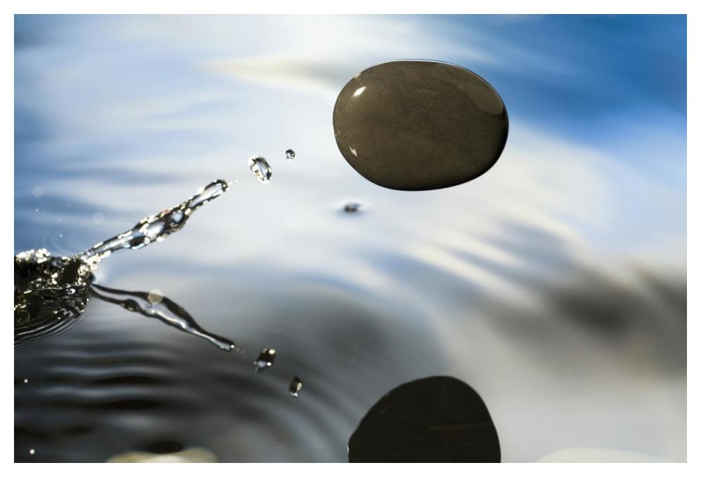 A rock skipping across the water's surface-Paper Art-50"x34"