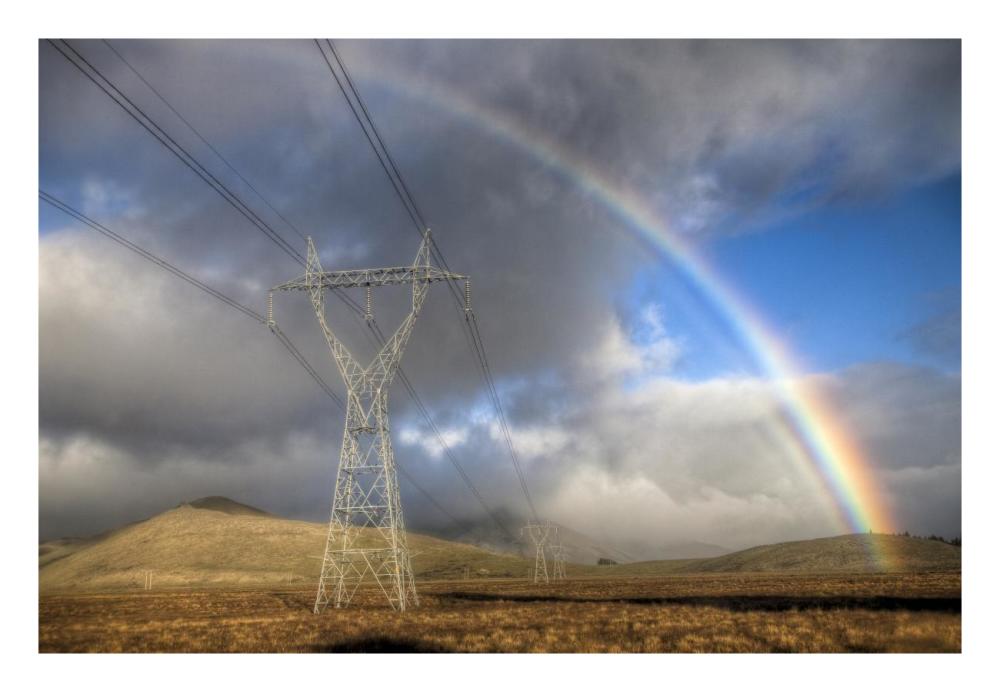 Powerlines, rainbow forms as evening sun lights up rain clouds, Canterbury, New Zealand-Paper Art-26"x18"