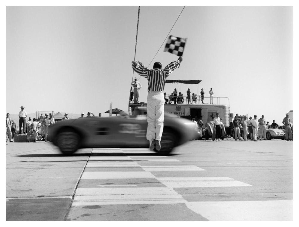 Man jumping waving checkered flag-Paper Art-50"x38"