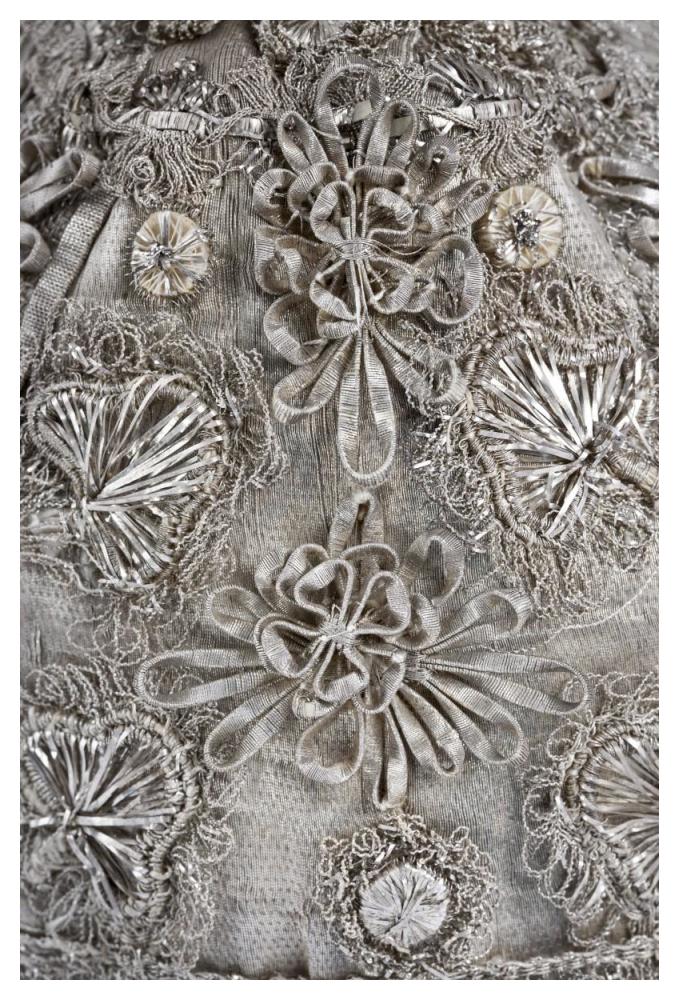Detail of elaborate silver embroidery on a child's bonnet-Paper Art-34"x50"